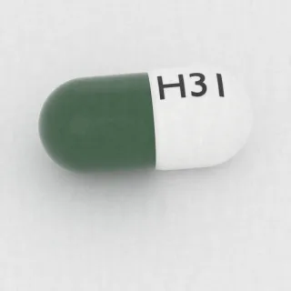 Carvedilol 10 mg capsule: white and green, 14 mm, imprinted H31.