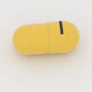 كبسولة بنزوناتات 100 mg: أصفر، 7 مم، النقش 1.