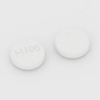 Acarbose 100 mg tablet: white, round, 9 mm, imprinted H100.