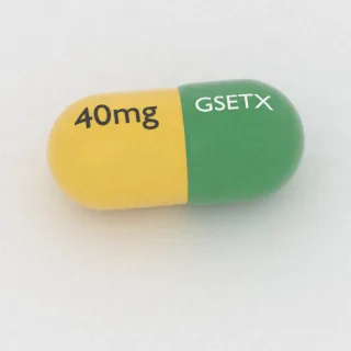 Carvedilol 40 mg capsule: green and yellow, 18 mm, imprinted GSETX on one side and 40mg on the other.