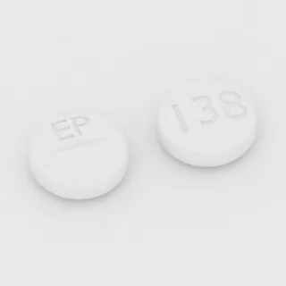 Benztropine 2 mg tablet: white, round, 7 mm, scored, imprinted EP on one side and 138 on the other.