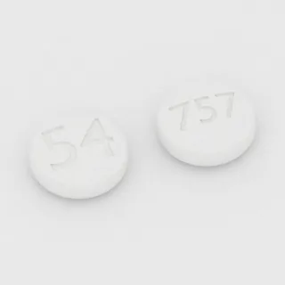 Tablet Silostazol 100 mg: putih, bulat, 7 mm, dengan kode cetak 54 di satu sisi dan 757 di sisi lainnya.