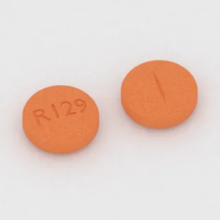 Clonidine 0.3 mg tablet: orange, round, 9 mm, scored, imprinted R129.