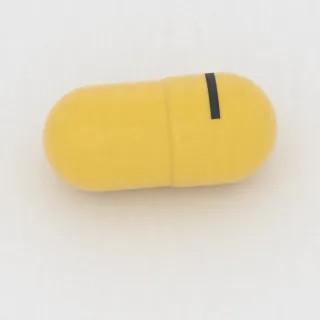 كبسولة بنزوناتات 100 mg: أصفر، 8 مم، النقش 1.