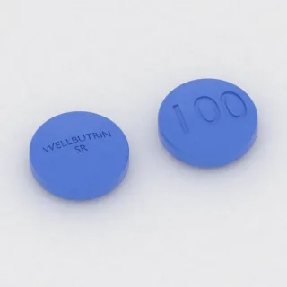 Bupropion 100 mg tablet: mavi, yuvarlak, 10 mm, üzerinde WELLBUTRIN SR 100 baskısı var.