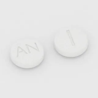 Anastrozole 1 mg en comprimé : blanc, rond, 6 mm, inscription AN sur une face et 1 sur l'autre.