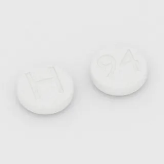 Karyzoprodol 250 mg, tabletka: biała, okrągła, 10 mm, z oznaczeniem H po jednej stronie i 94 po drugiej.