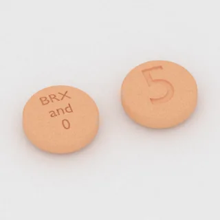 Brekspiprazol 0.5 mg tablet: turuncu, yuvarlak, 6 mm, üzerinde BRX and 0 5 baskısı var.