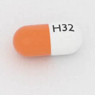 Carvedilol 20 mg capsule: white and orange, 16 mm, imprinted H32.