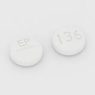 Benztropine 0.5 mg tablet: white, round, 6 mm, scored, imprinted EP on one side and 136 on the other.