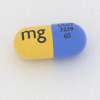 Atomoxetine 60 mg capsule: blue and yellow, 18 mm, imprinted LILLY 3239 60 mg.