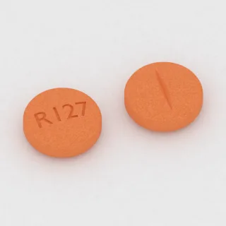 Clonidine 0.1 mg tablet: orange, round, 6 mm, scored, imprinted R127.
