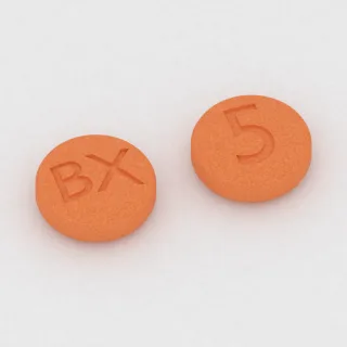 Brekspiprazol 0.5 mg, tabletka: pomarańczowa, okrągła, 6 mm, z oznaczeniem BX po jednej stronie i 5 po drugiej.