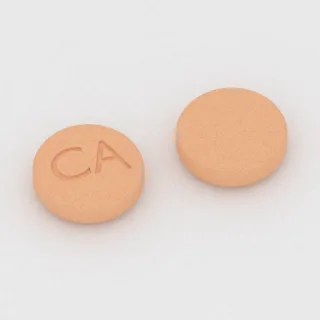 Amantadine 100 mg tablet: orange, round, 7 mm, imprinted CA.