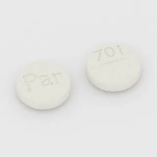 Tablet Klomifen 50 mg: putih, bulat, 9 mm, bergaris bagi, dengan kode cetak Par di satu sisi dan 701 di sisi lainnya.