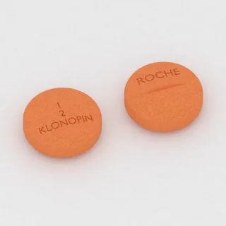 क्लोनाज़ेपाम .5 mg टैबलेट: नारंगी, गोल, 9 mm, विभाजन रेखा सहित, इम्प्रिंट 1 2 KLONOPIN ROCHE।