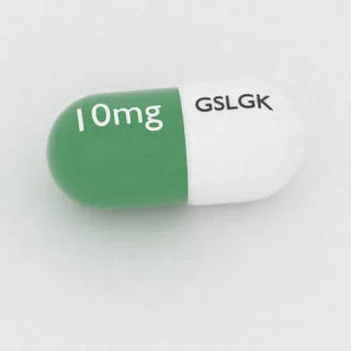 Carvedilol 10 mg capsule: white and green, 14 mm, imprinted GSLGK on one side and 10mg on the other.