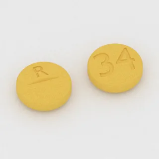 Clonazepam 1 mg Tablette: gelb, rund, 8 mm, mit Bruchkerbe, Prägung R auf der einen Seite und 34 auf der anderen.