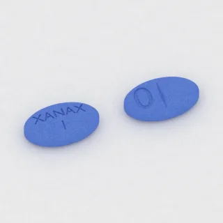 Alprazolam 1 mg Tablette: blau, oval, 9 mm, mit Bruchkerbe, Prägung XANAX 1 0.